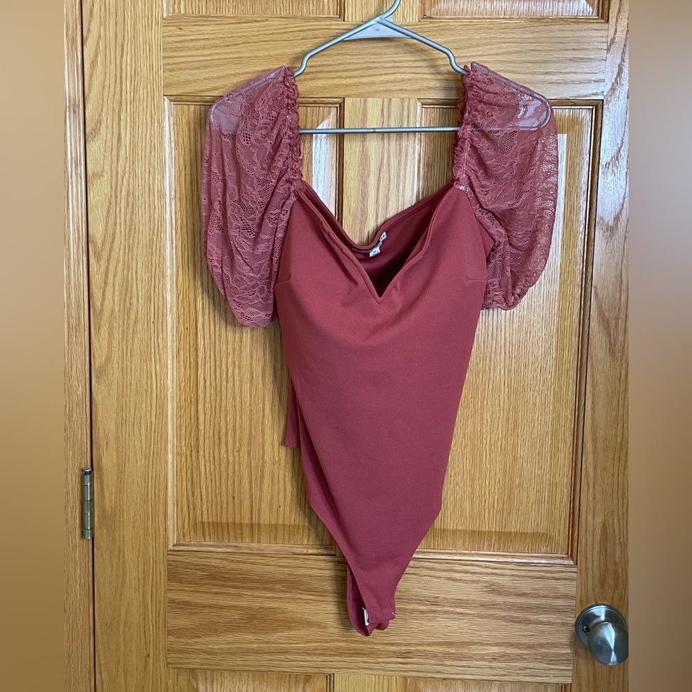 Pink bodysuit with lace puff sleeves